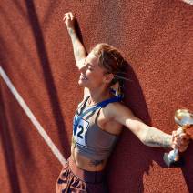female-athlete-celebrates-victory-with-trophy-on-t-2026-01-09-07-11-23-utc